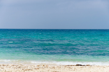 Fototapeta na wymiar Beautiful sunny beach with turquoise waters and white sand