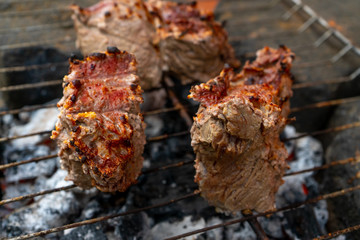 Prepairing roast beef barbecue on rustic grill 