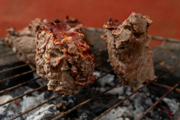 Prepairing roast beef barbecue on rustic grill 