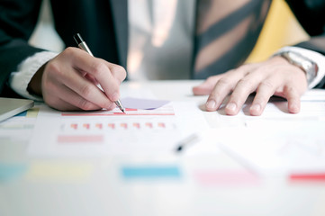 Businessman working with data document graph chart report or marketing research, development at office.