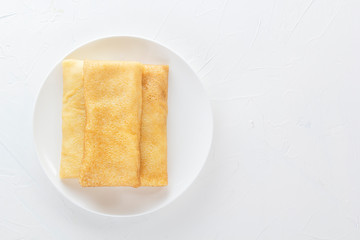 Chinese tortillas - bings in a plate on a white background.View from above. Copy space