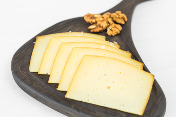 Fresh products. Sliced cheese on rustic table.