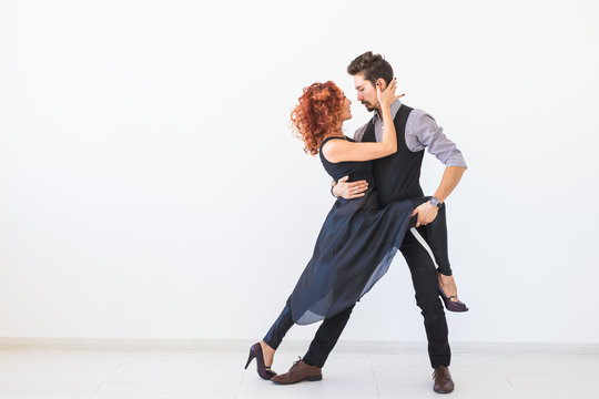 Social Dance, Kizomba, Tango, Salsa, People Concept - Beautiful Couple Dancing Bachata On White Background With Copy Space