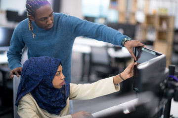 young black muslim female software developer at work