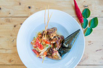 A Green papaya salad, grilled chicken and sticky rice