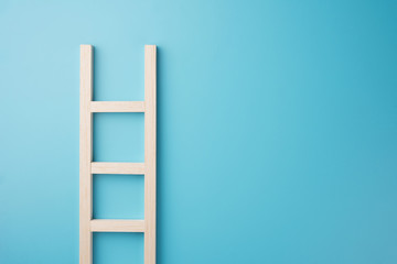 Wood staircase isolated on blue wall texture background  business growth concept photo object design