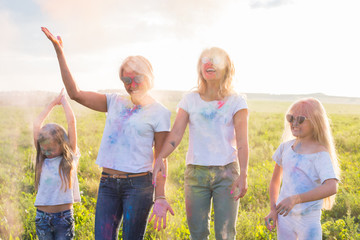 Fototapeta premium Fun, colors, Indian holidays and people concept - young female people having fun on the festival of holi