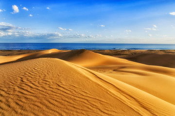 Dunes sea blue sky
