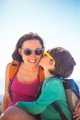 Portrait of a woman with her son on the top of the mountain.