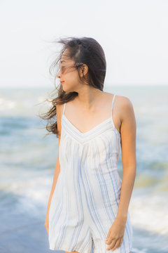 Portrait beautiful young asian woman happy smile relax around neary beach and sea