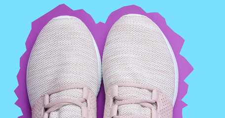 Sneakers. Sports shoes on purple paper blue background. Overhead shot of running shoes. Zine style. Top view