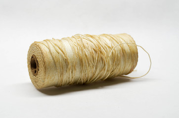Unprotected spool of braided nylon cord exposed to workshop environment