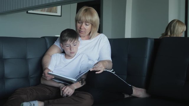 Mom helps my son do homework in the living room. The concept of a happy family