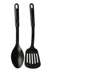 Hand with Black plastic kitchen spoon and spatula, kitchenware for cooking