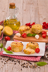 Potato gratins with mozzarella and tomatoes.