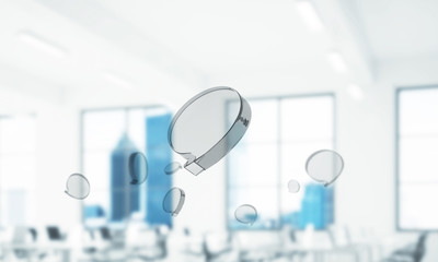 Concept of communication by glass empty chat icon on office background. Mixed media