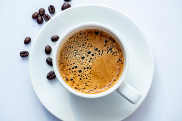 Top view of a cap of coffee white background