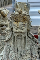 Close up the ancient Chinese warrior stone statues at wat Pho the temple in Bangkok,Thailand.