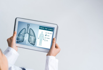 Close of female doctor hands working with tablet pc computer