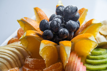 Mixed fruit in white plate isolated on white background - Healthy food style