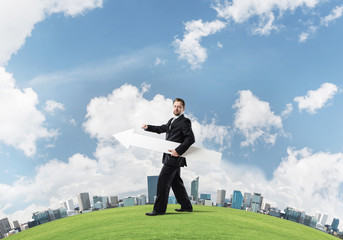 Conceptual image of businessman pointing aside