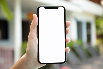 female hand holding phone with isolated screen on background house