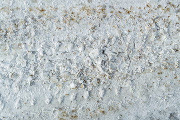 Tire tracks in the snow. Dirty snow spring background. Spring time. Old and dirty snow texture. Natural background