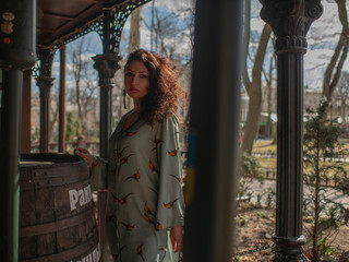 young beautiful girl with spinning hair on the street near the lanterns and a large barrel