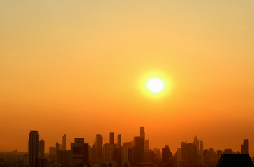 Fototapeta na wymiar Stunning sunset sky over the silhouette of skyscrapers of Bangkok downtown 