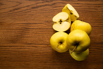 Yellow apple on the wooden vintage background