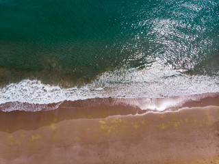 Waves splashing the sea shore aerial view