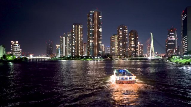 Boat at night cruising down the Sumida river in Tokyo