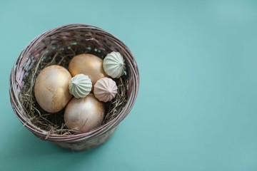 Easter chicken eggs in a basket with hay.