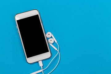 headphones and smartphone on  blue background