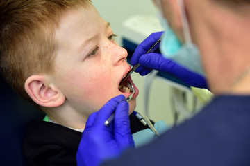 A dentist treats a patient's child in a dental office in a pleasant environment.Dentist, Child, Dental Hygiene