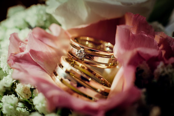 Wedding rings close-up lie on the wedding bouquet of flowers