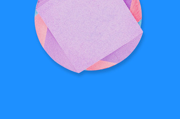 One spiral block of multi colored square blank paper stickers on blue office table. Top view. Copy space for your text. Business or education concept