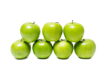 Green apples stacked isolated on white background