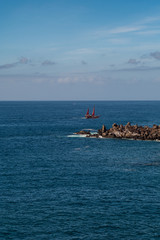 beautiful view on ocean water and black lava sand
