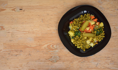 Vegetables on a black plate.