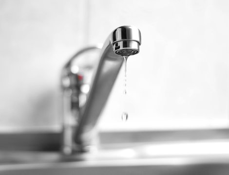 Water Is Dripping From A Metal Water Tap. Close Up