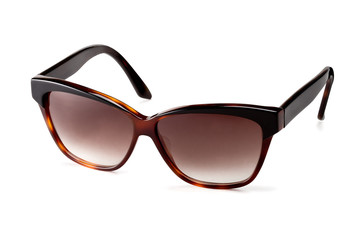 Stylish women's brown sunglasses on a white background. In half a turn.