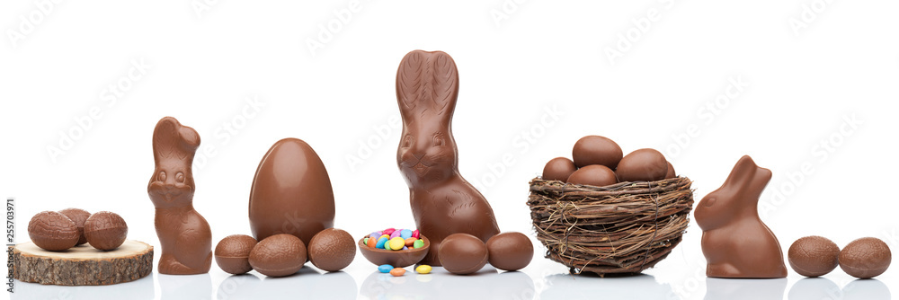 Sticker chocolate easter bunny, eggs and sweets on white background