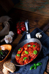 Baked mini meatballs in tomato sauce with basil