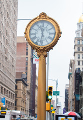 Fototapeta na wymiar Cast iron street clock on fifth avenue, madison square. Wide angle shot with flatiron and skyline, New York, USA