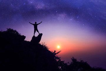 Man standing on the mountain with  million stars galaxy