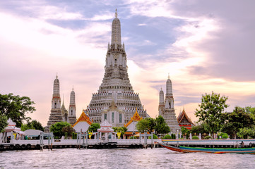 Temple of Dawn in Bangkok Thailand. Sitting majestically on the Thonburi side of the Chao Phraya River, the legendary Wat Arun is one of the most striking riverside landmarks of Thailand.