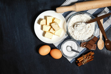 Ingredients for baking a chocolate cake or brownie on a dark background