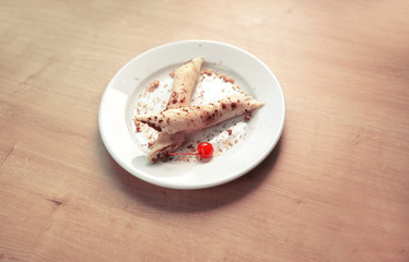 original blueberry cheesecake on white plate on wooden backgroynd