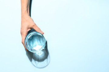 Woman's hand holding glass of water